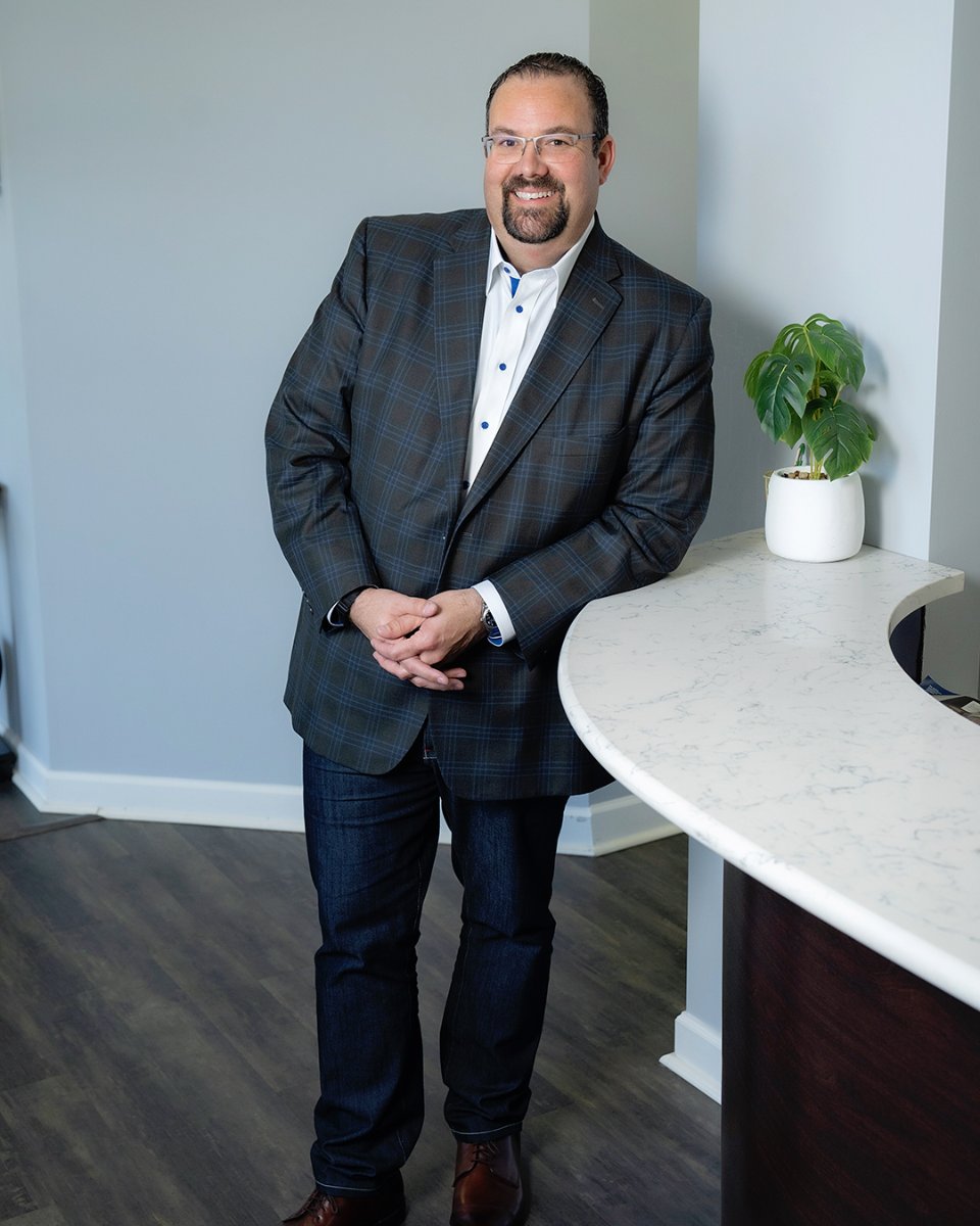 A professional headshot of Nick Bour, Founder & CEO of Inspire Wealth in Brighton, MI